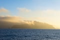 Island engulfed in clouds